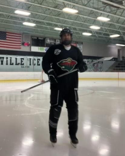 Owner of St. Paul MN drywall company showing Minnesota hockey pride — local drywall contractor dedicated to quality work